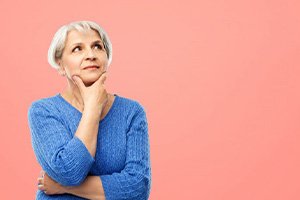 Lady considers fit of her dentures