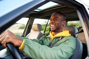 Man smiles while driving