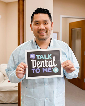 Dr. Lam holding a sign