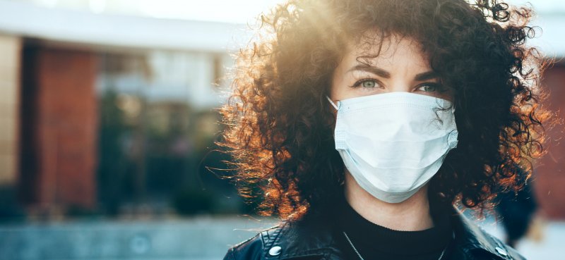 A woman practicing dental office safety in Mesquite.