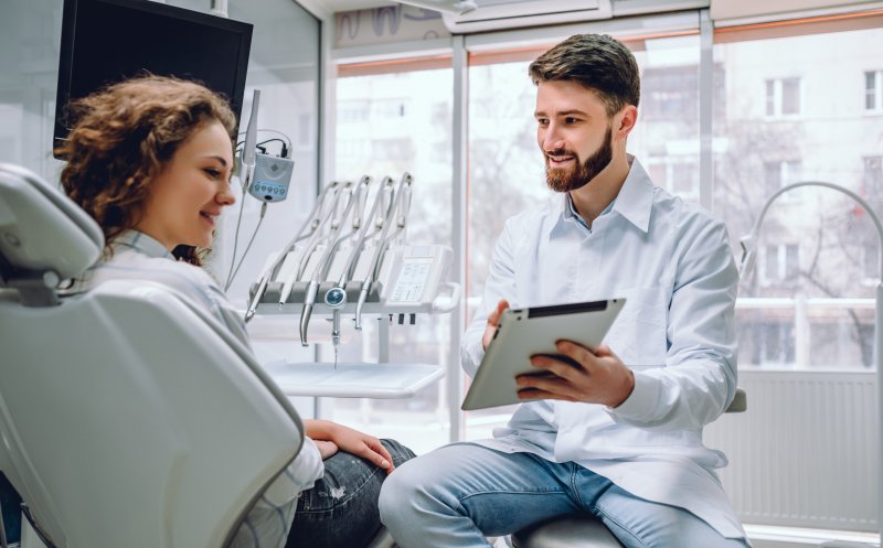 dentist speaking with dental implant candidate in Mesquite
