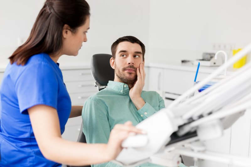 a dentist explaining facts about root canal therapy in Mesquite