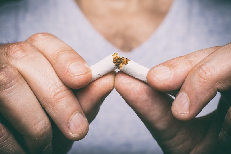 Someone breaks cigarette
